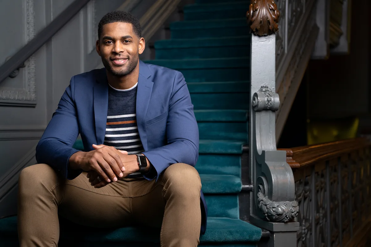 Marques Colston seated on a staircase